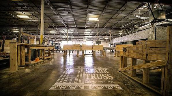 Stark Truss manufacturing facility floor with company logo